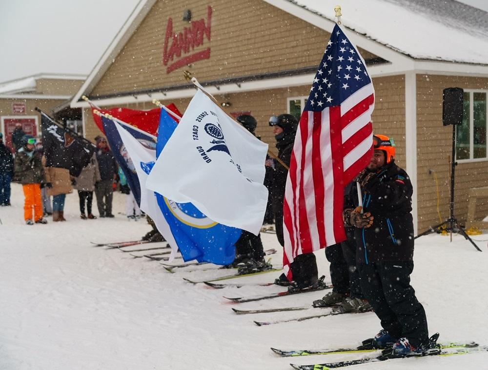 Service members stand proud with their branch flags