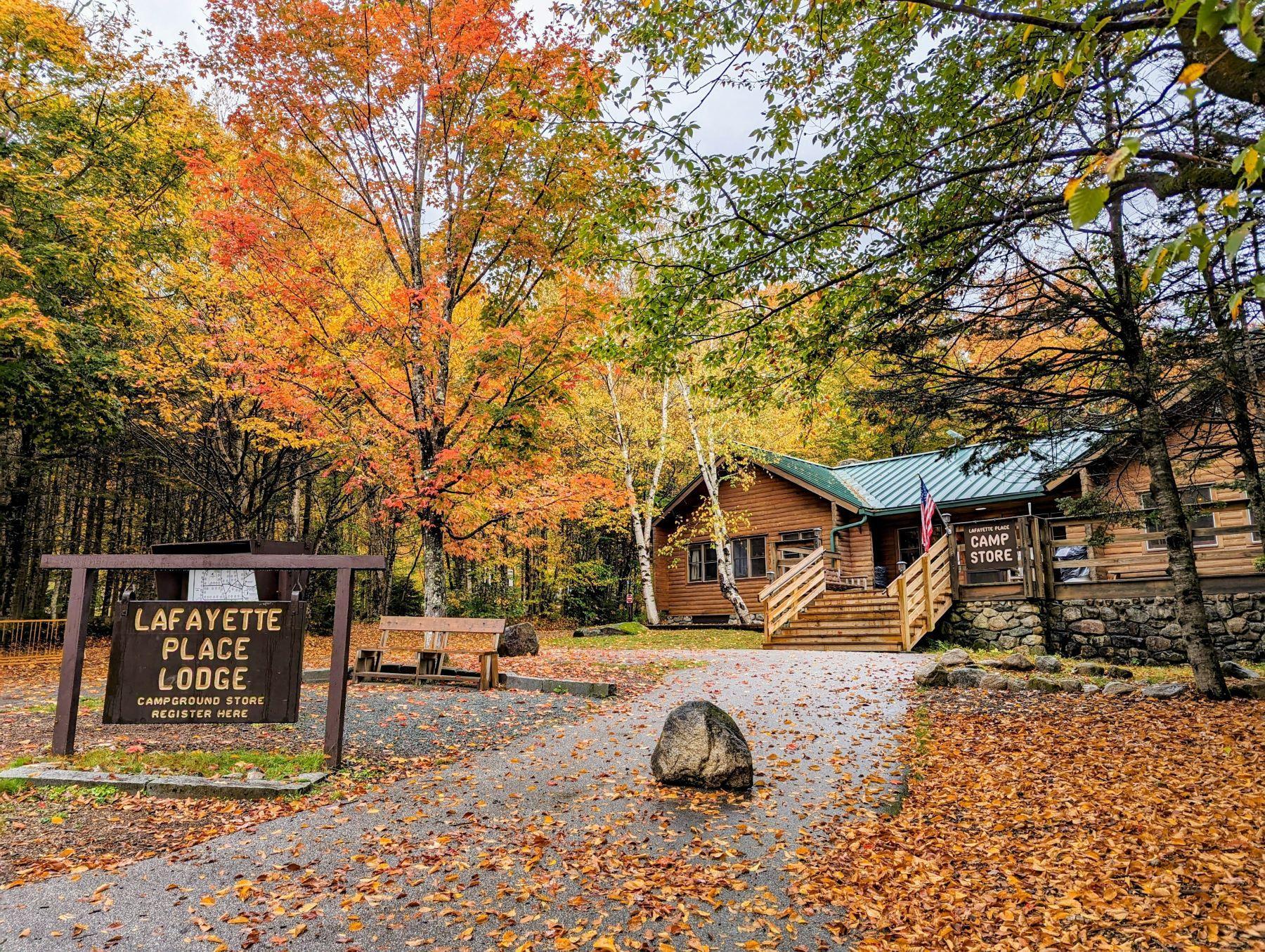 Lafayette Place campground lodge with fall trees and leaf litter on the ground.